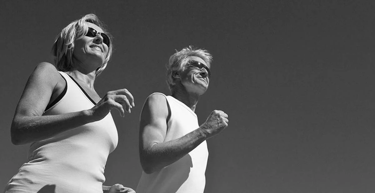 Senior couple running outdoors.