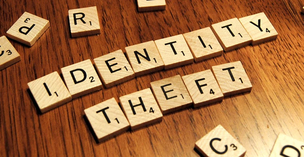 The word "Identity Theft" spelled out in scrabble tiles.