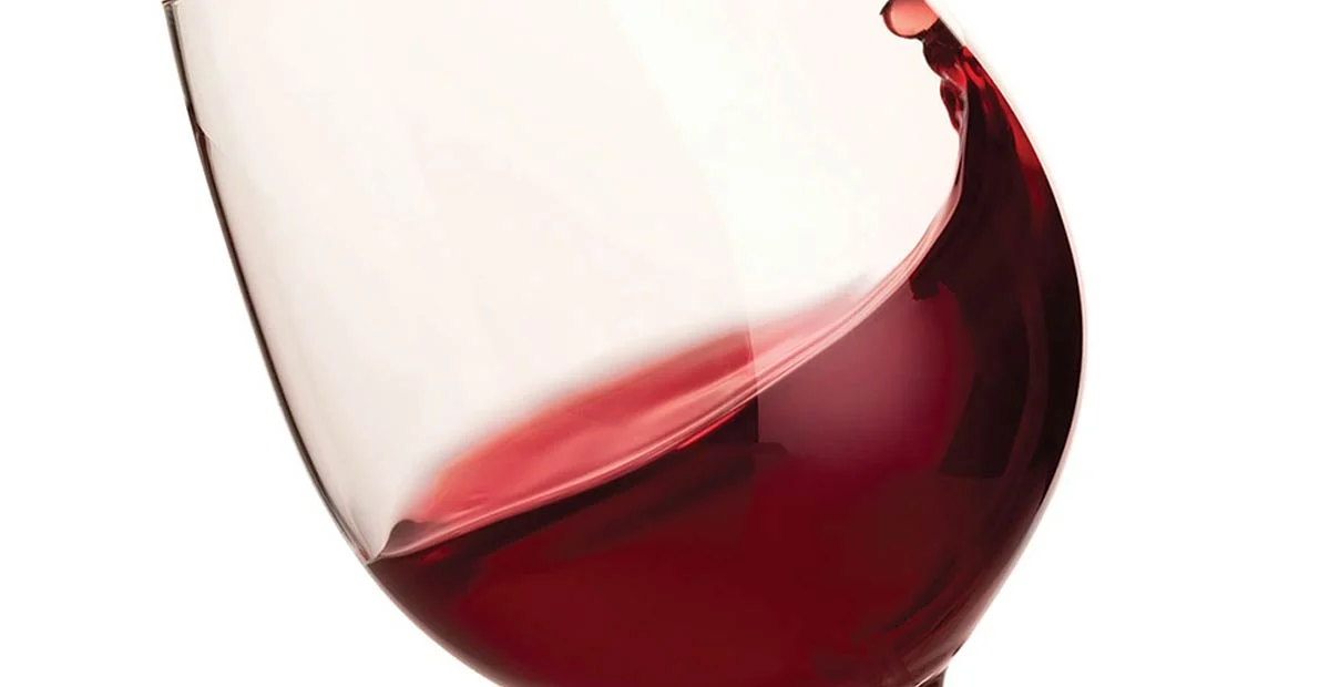 Closeup of red wine swirled in a glass.