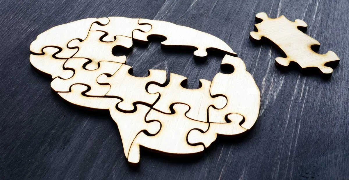 Brain-shaped puzzle with a missing piece to the side.