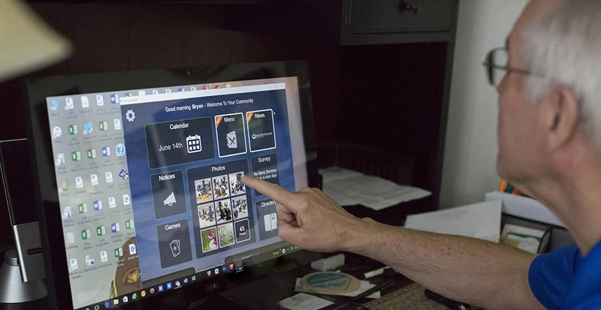 Senior man using touch screen computer.