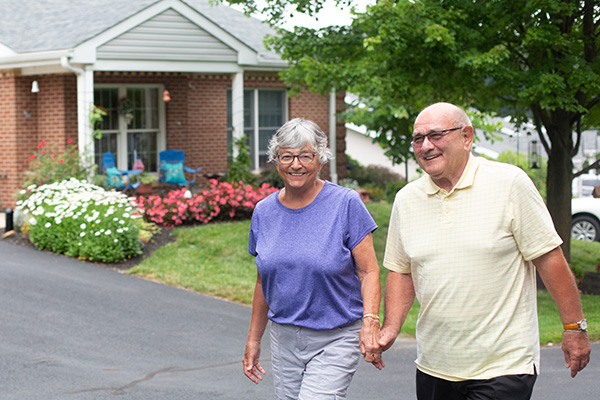 couple walking outdoors by cottage