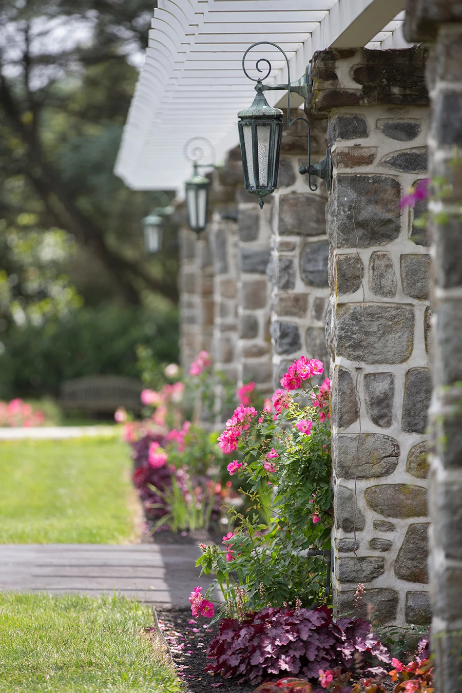 858A3801 Stone columns in a row with gardens at their feet.