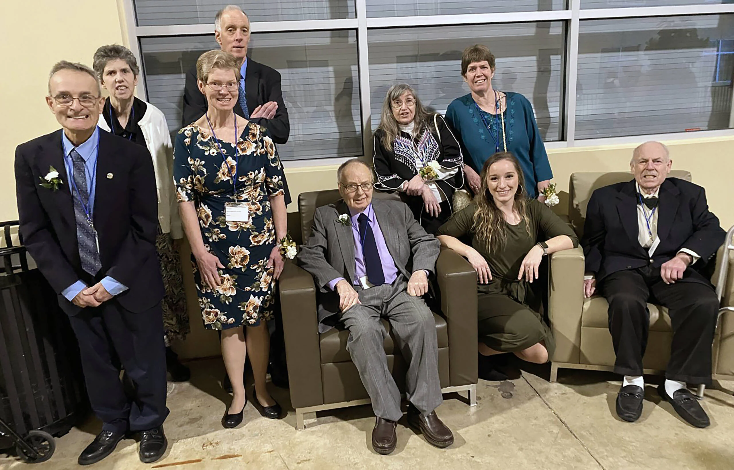 Mature adults from the Bleiler Caring Cottage seated and standing in formal attire.