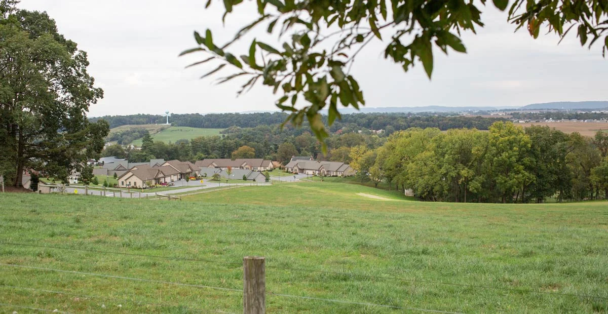 Landscape of Masonic Village farm and cottages in the background.