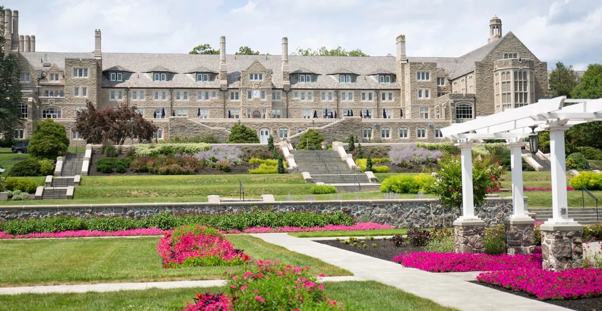 Grand Lodge Hall, a large stone building with stairs leading up to it and Formal Gardens sprawling in front of it.