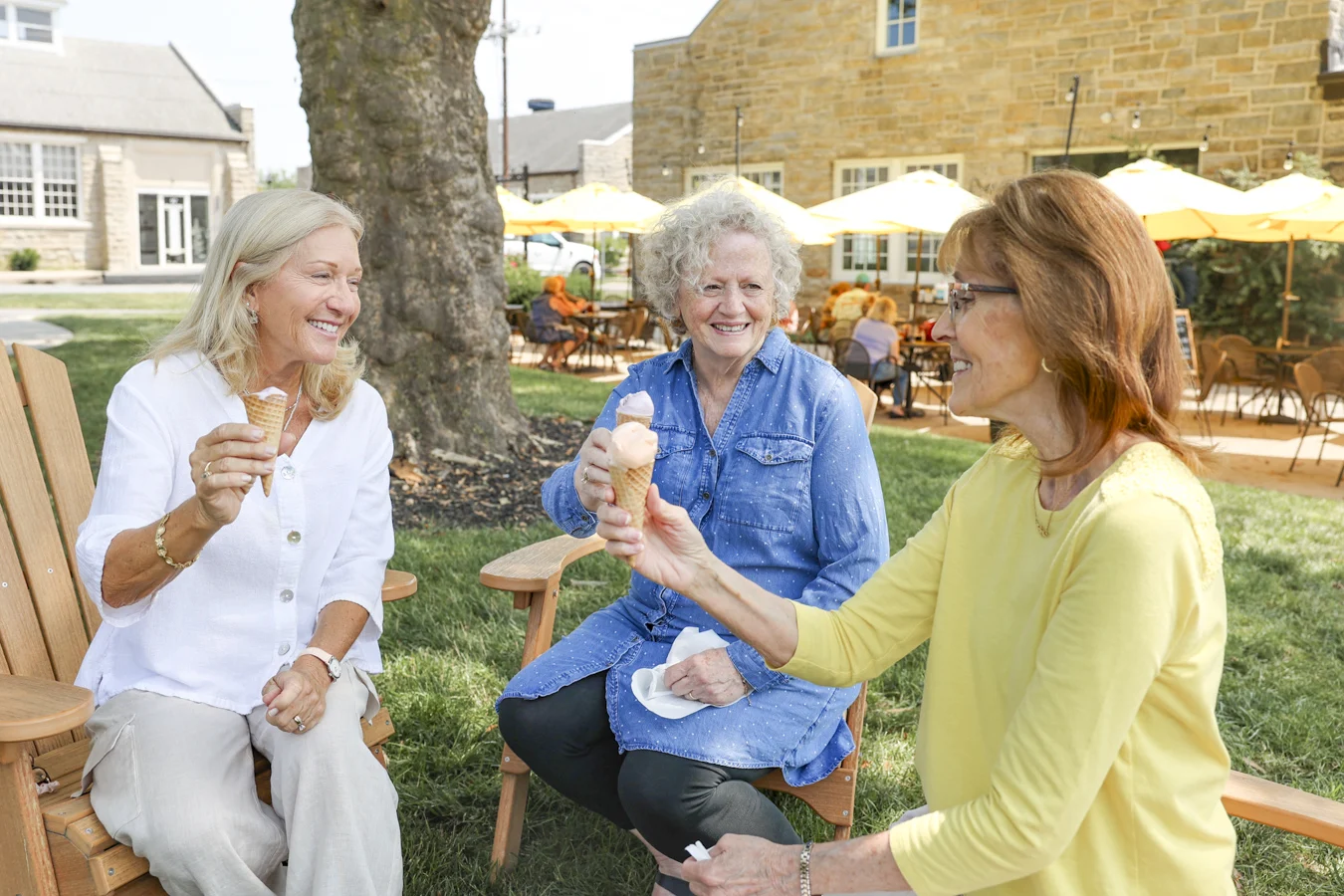 Group of senior women smiling and holding ice cream cones.