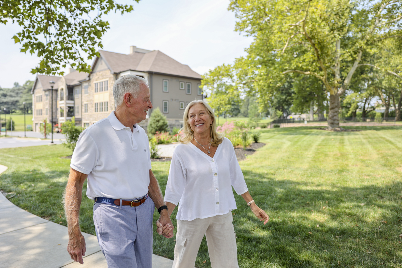 Couple holding hands and walking outdoors