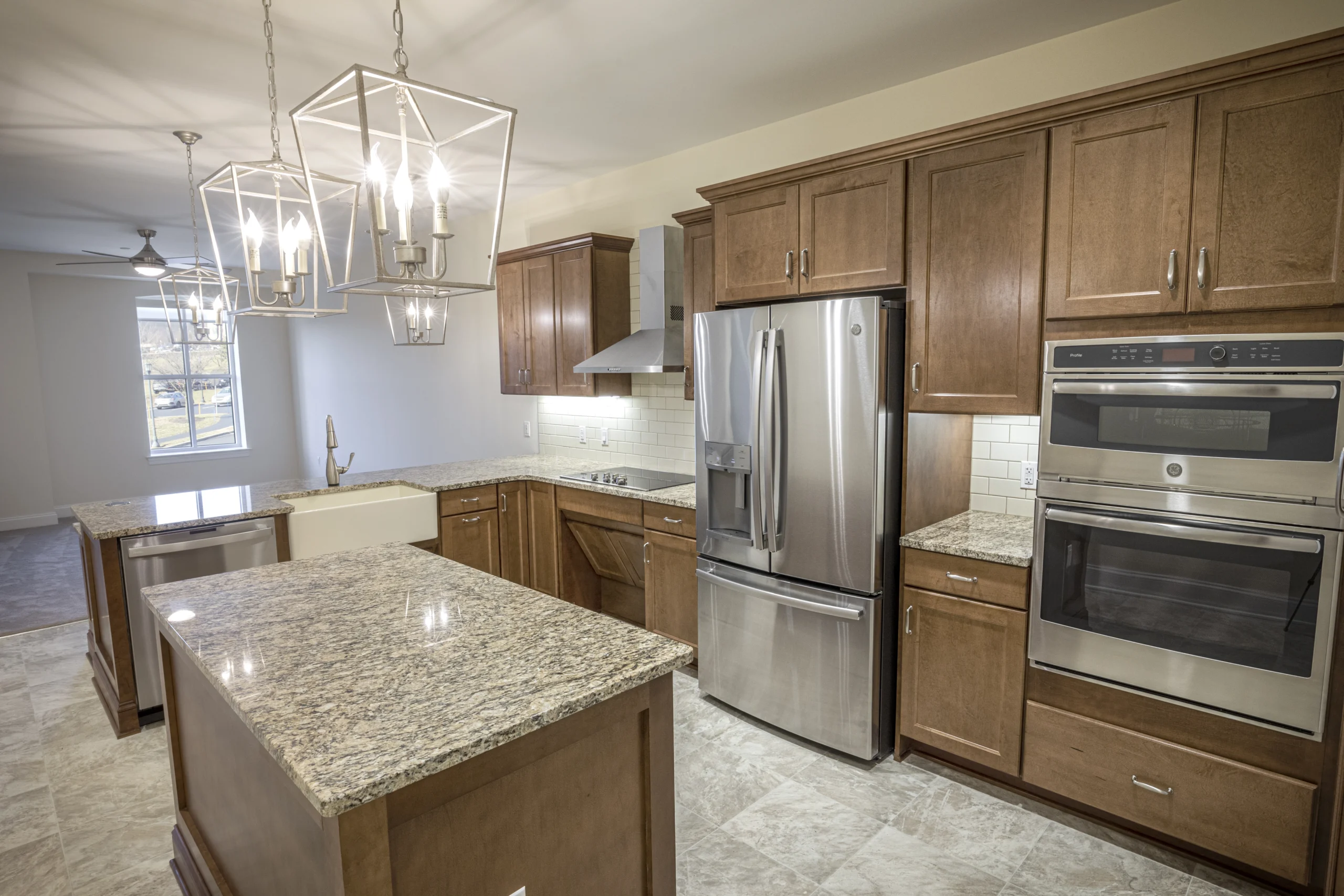 DU3A4386 Spacious kitchen with wooden cabinets and an island in the center.
