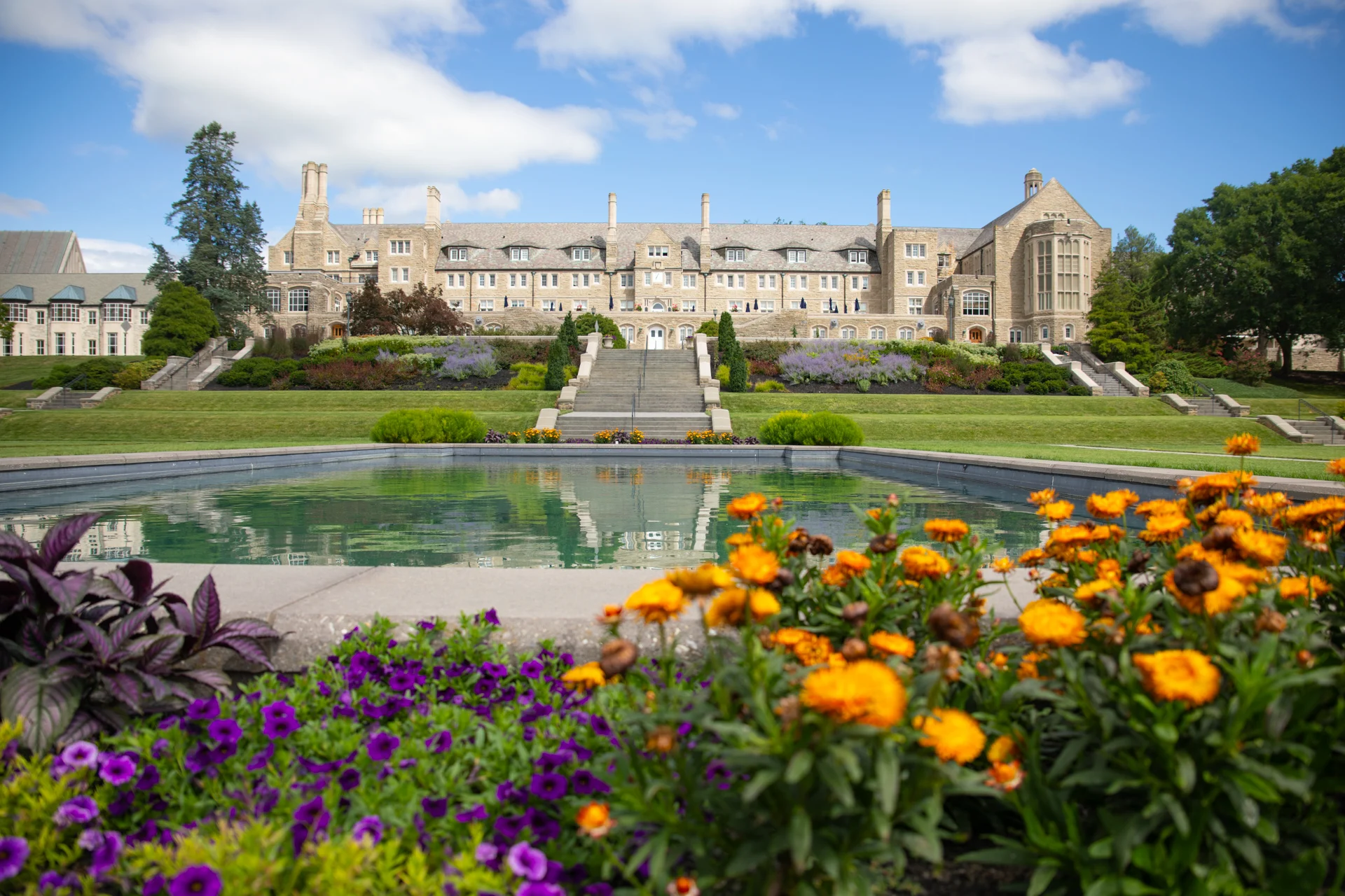 2V9A9183 Landscape with large stone building in the distance with gardens and reflecting pool in the foreground.