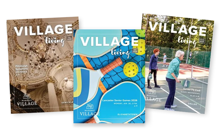 Overlapping Village Living magazines featuring off-campus excursions, pickleball equipment and women playing pickleball outdoors.